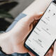 Man holding phone that shows Instagram metrics.